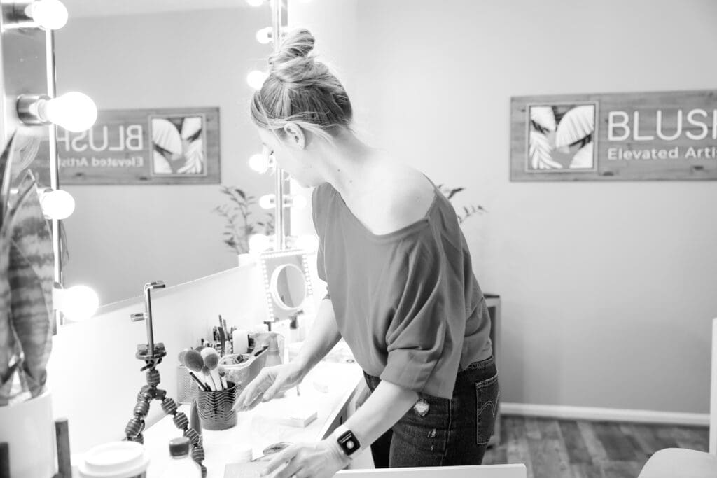 Black and white image of female makeup artist setting up her supplies | 5 Photos Every Small Business Needs | Kayla Petrosky Photography