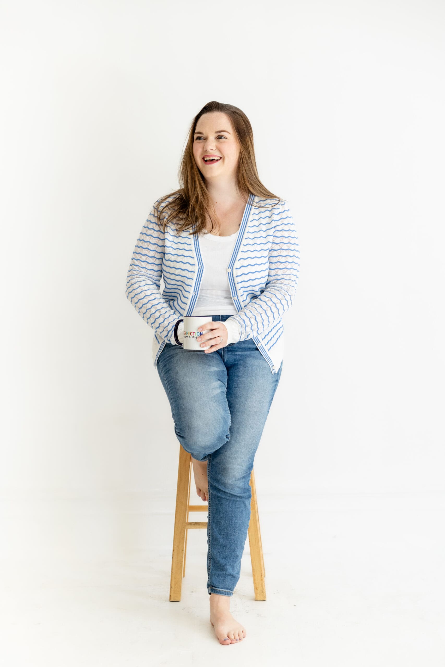Woman sits on a stool while holding a coffee mug | Tell your brand's story | Kayla Petrosky Photography