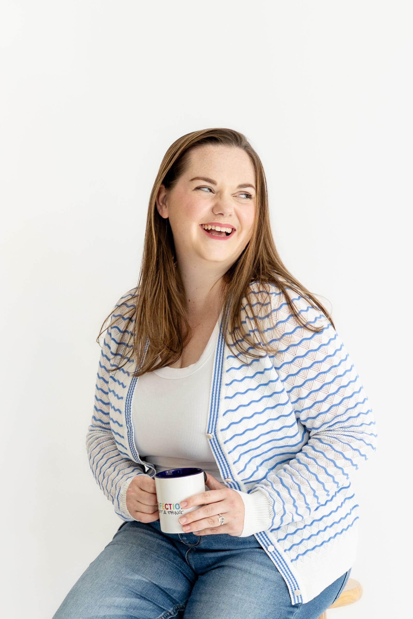Woman laughs and looks off-camera