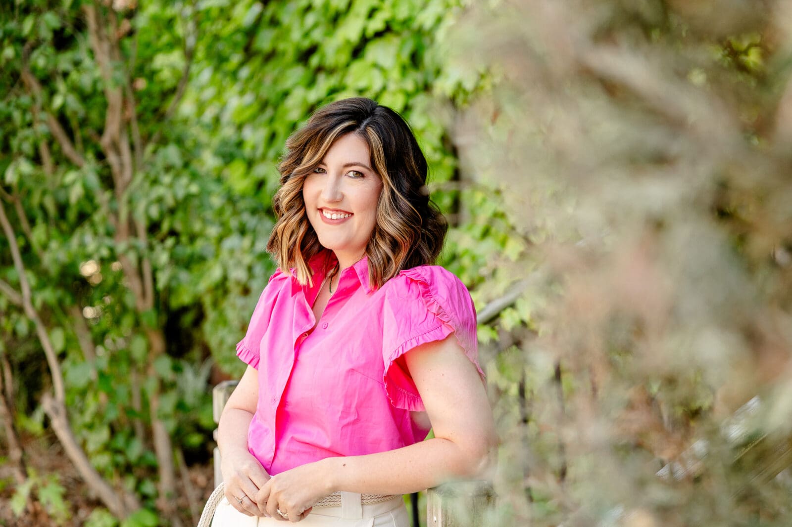 Woman leans on railing and looks at camera | Confidence-boosting photoshoot in downtown Lafayette | Kayla Petrosky Photography