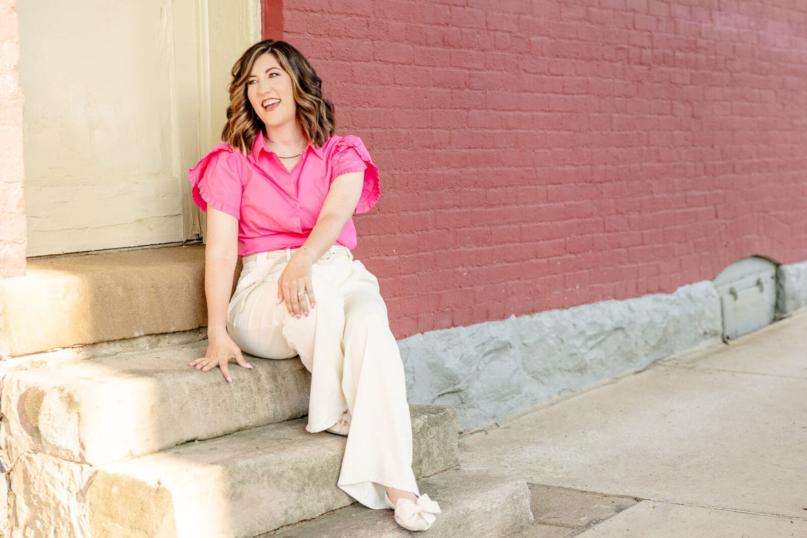 Woman sits on stairs and laughs | Confidence-boosting photoshoot in Downtown Lafayette | Kayla Petrosky Photography