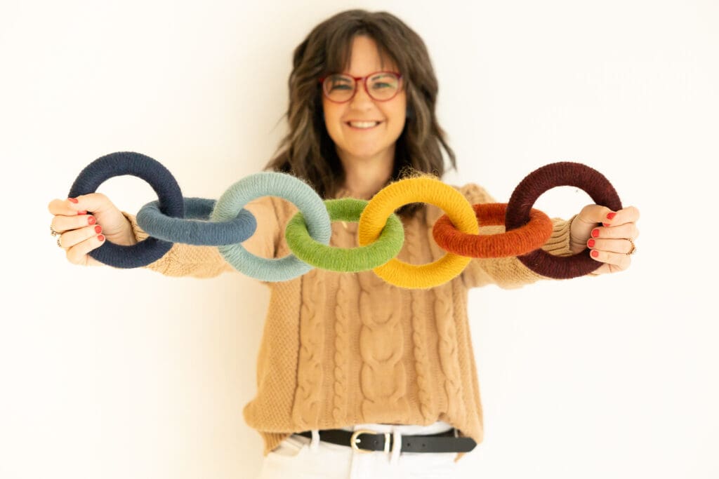 Woman holds interlocking rainbow rings | Indiana Perinatal Therapist Brand Photos | Kayla Petrosky Photography