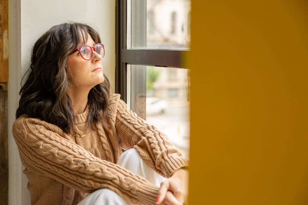 Woman looks out window | Indiana Perinatal Therapist | Kayla Petrosky Photography