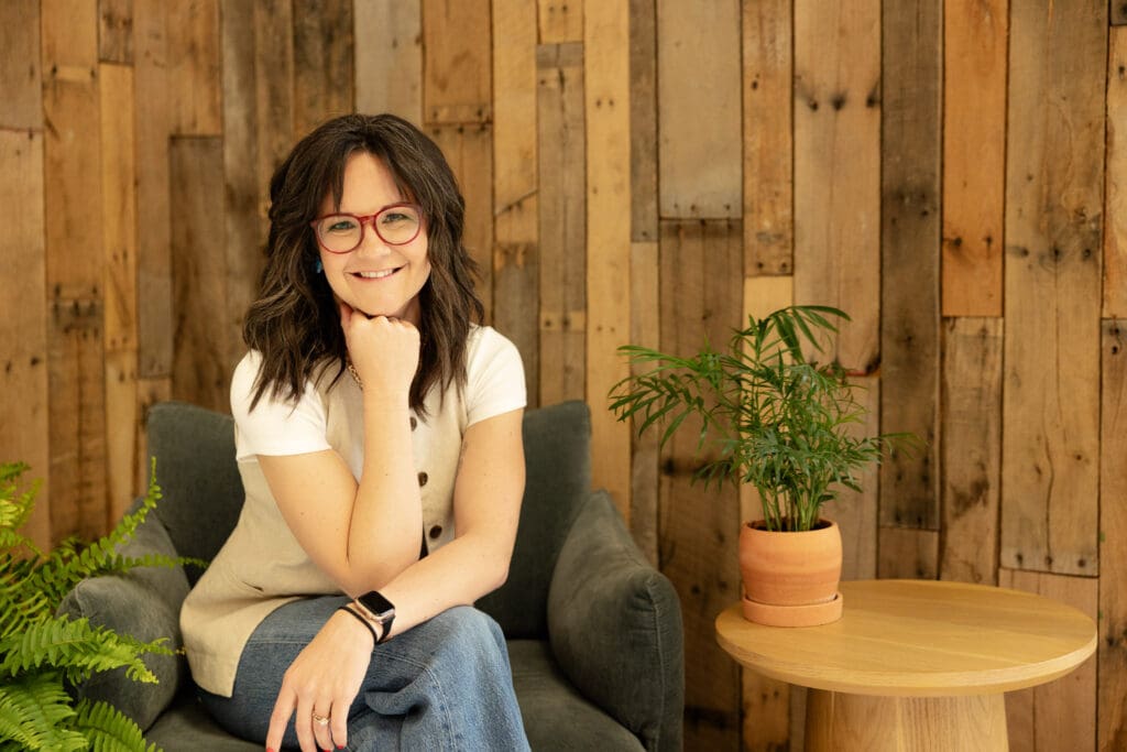 Woman sits in chair and smiles at camera | Indiana Perinatal Therapist Brand Photos | Kayla Petrosky Photography