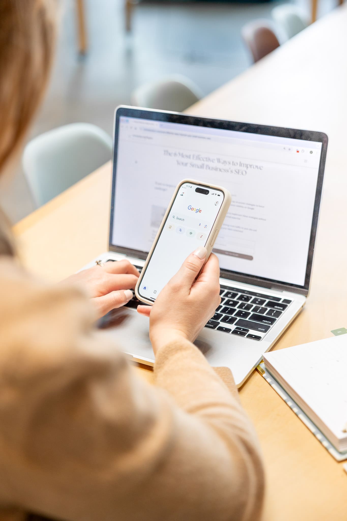 Person holds phone with Google pulled up while working on website on computer | SEO + Marketing Expert Brand Photos | Kayla Petrosky Photography