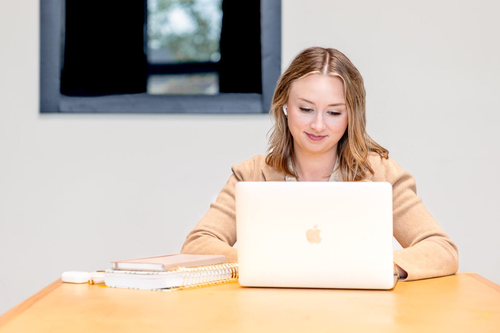 Woman sits at a desk to work on laptop | Kayla Petrosky Photography