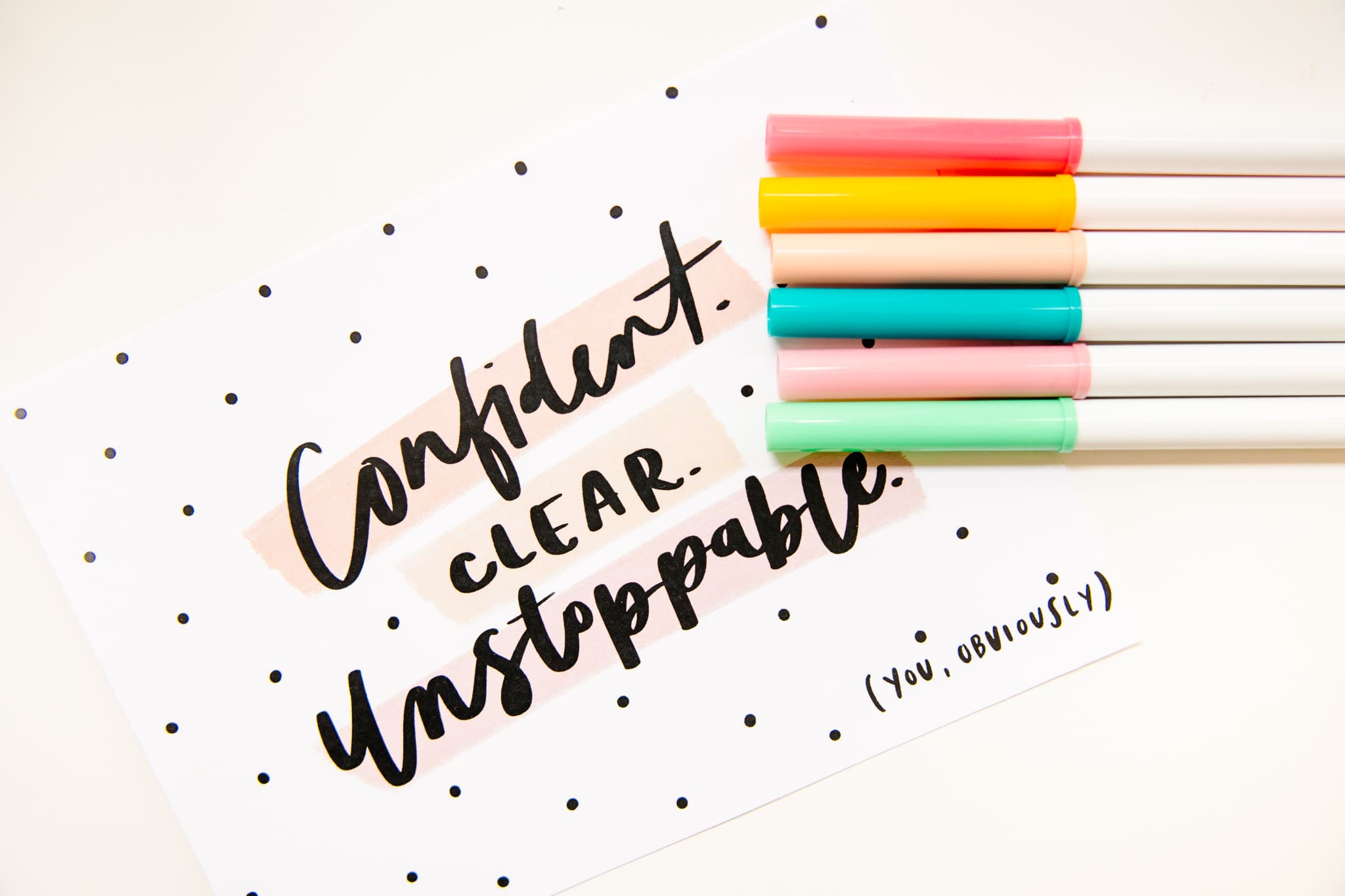 Card with words "Confident. Clear. Unstoppable" on it layered with colorful markers | Brand Photo Process | Kayla Petrosky Photography