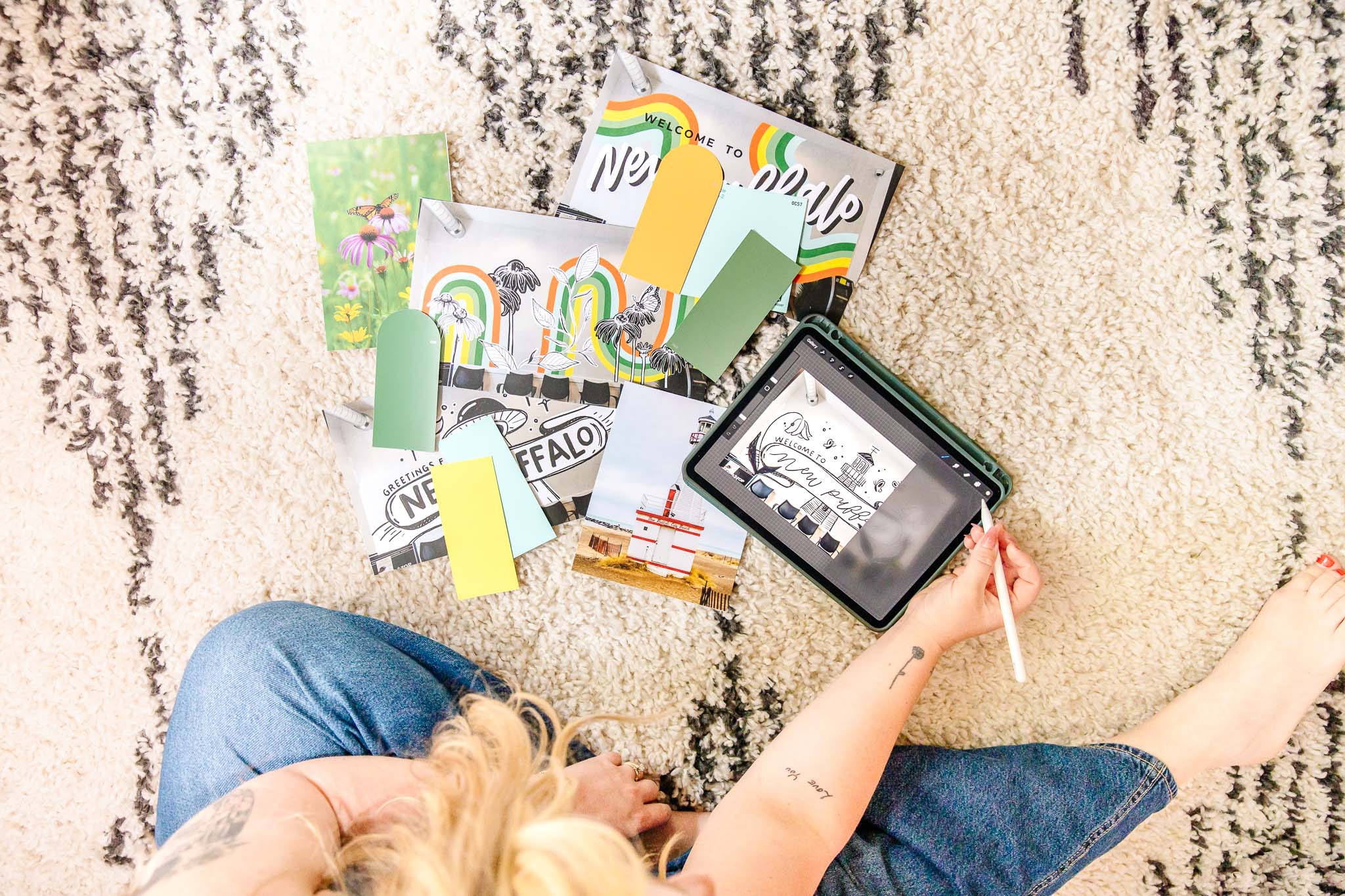 Person sits on floor to design a mural using images, paint swatches, and an iPad | Brand photos with Lafayette Lettering | Kayla Petrosky Photography