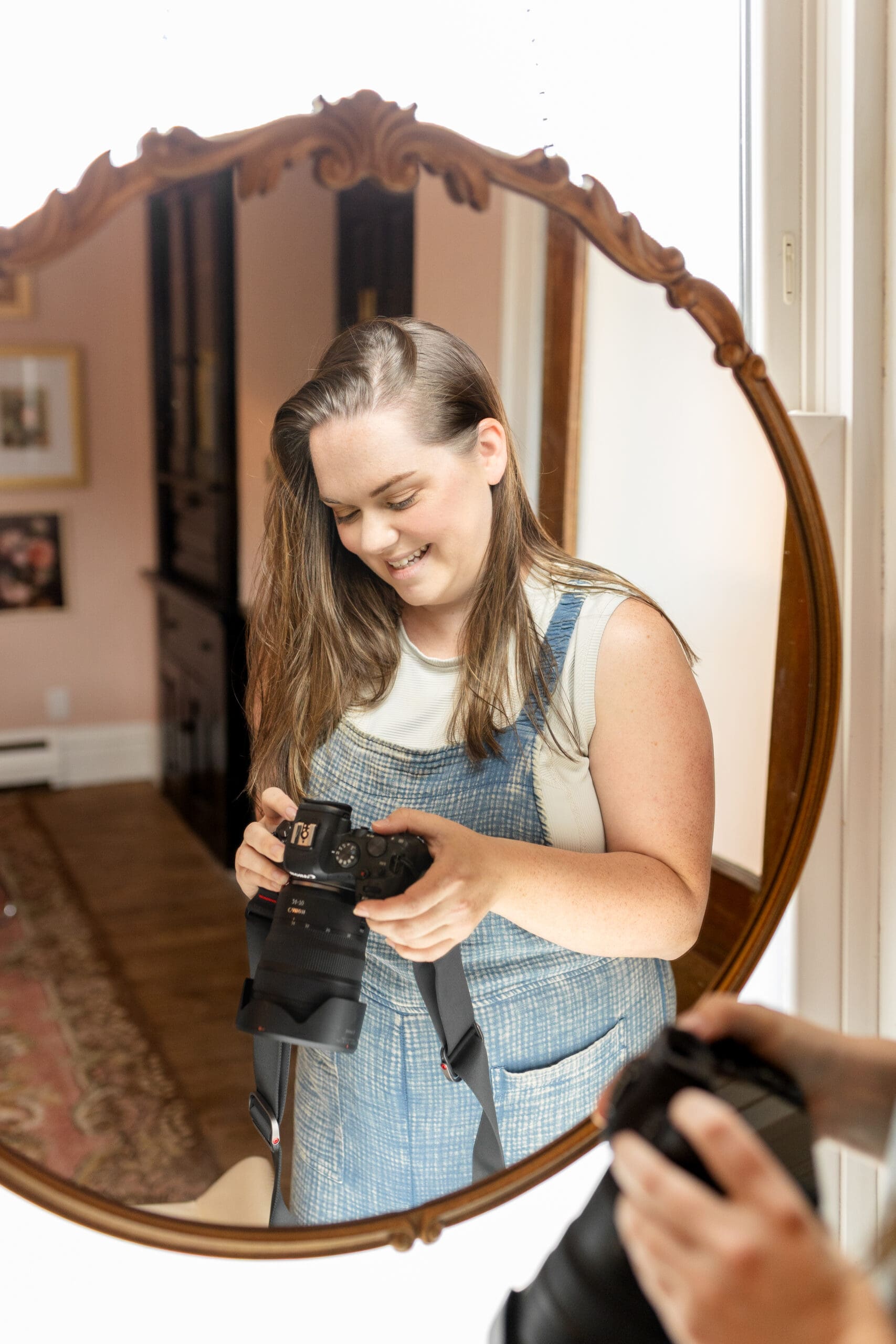 Woman looking at camera is reflected in a mirror | Kayla Petrosky Photography