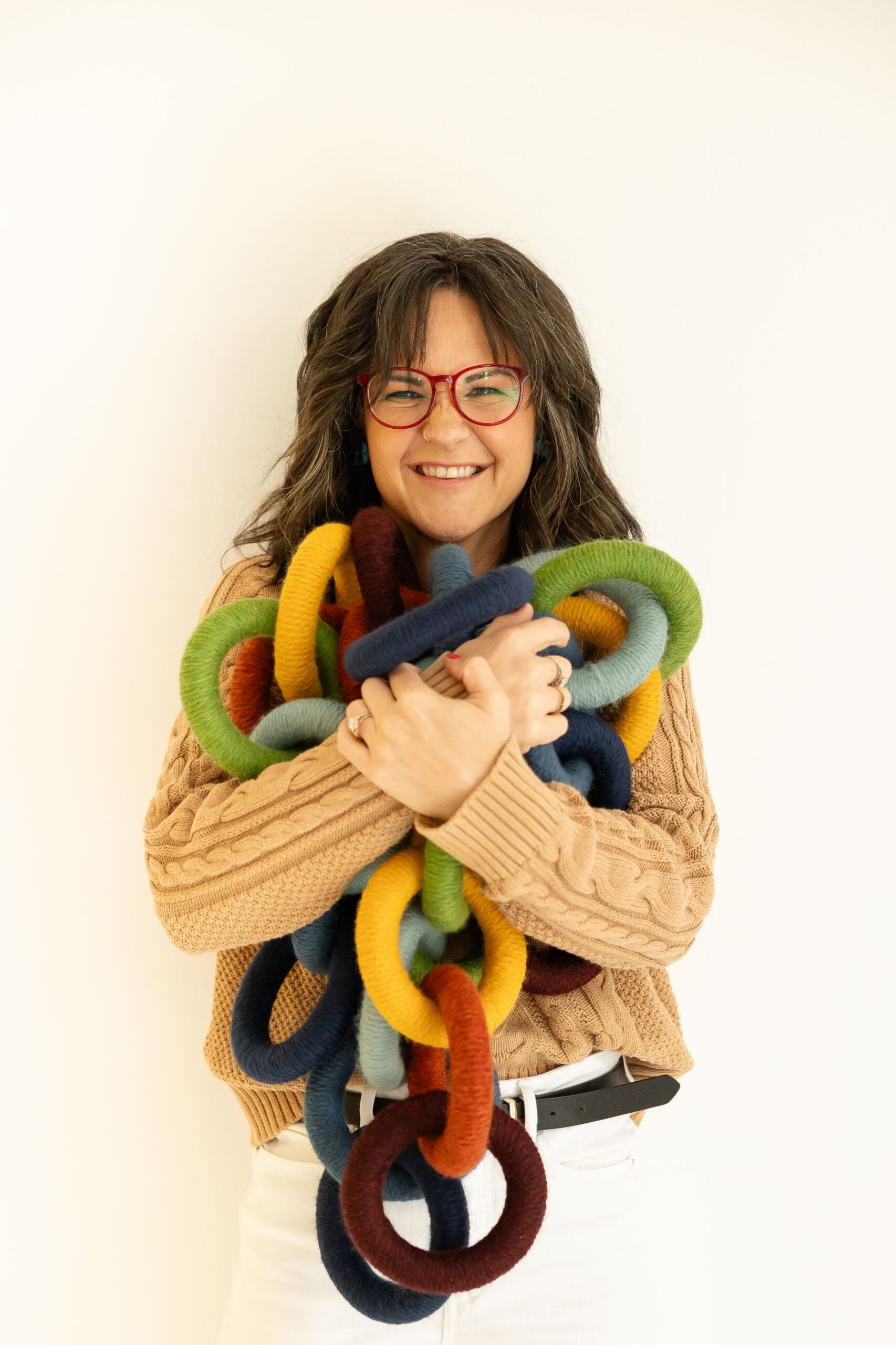Woman hugs collection of rainbow rings | How to Choose Your Brand Photographer | Kayla Petrosky Photography