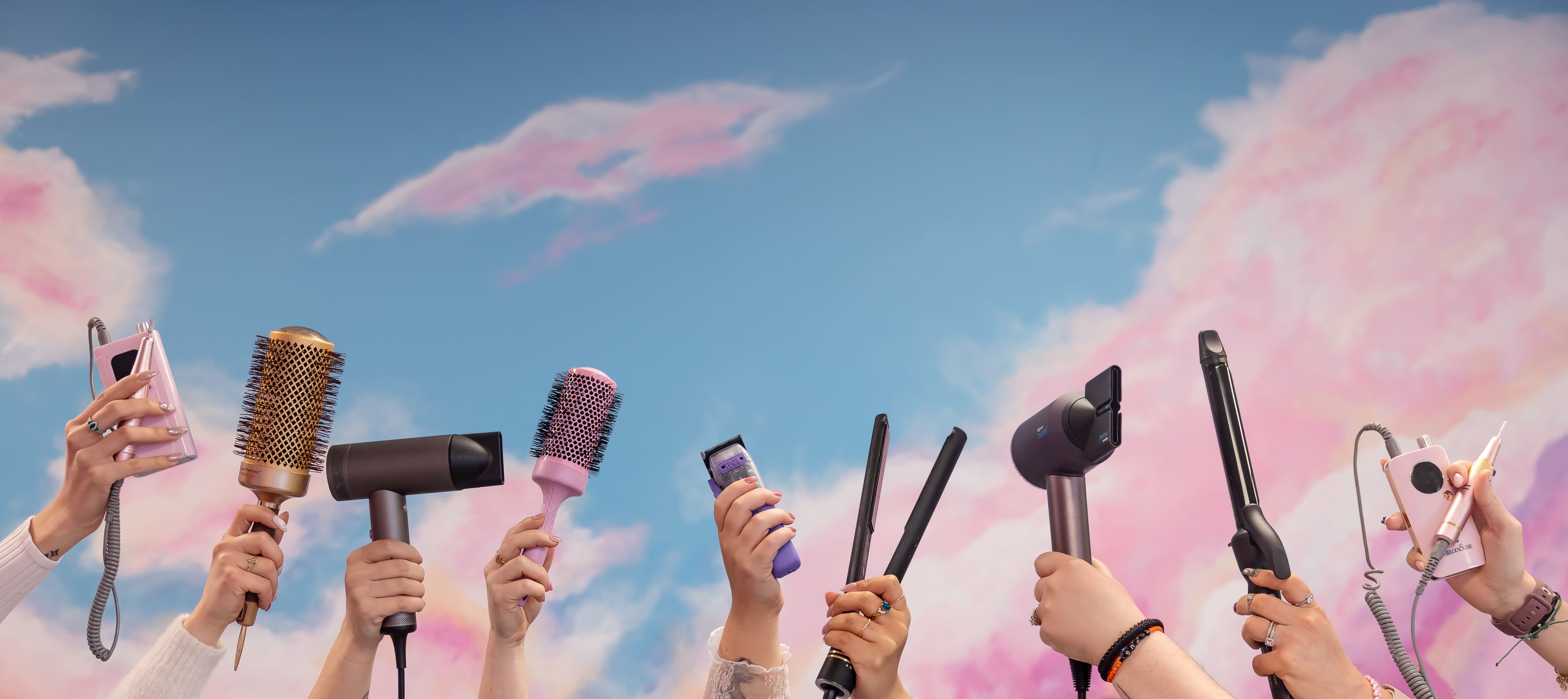 Various hands hold up a selection of hair and nail salon tools
